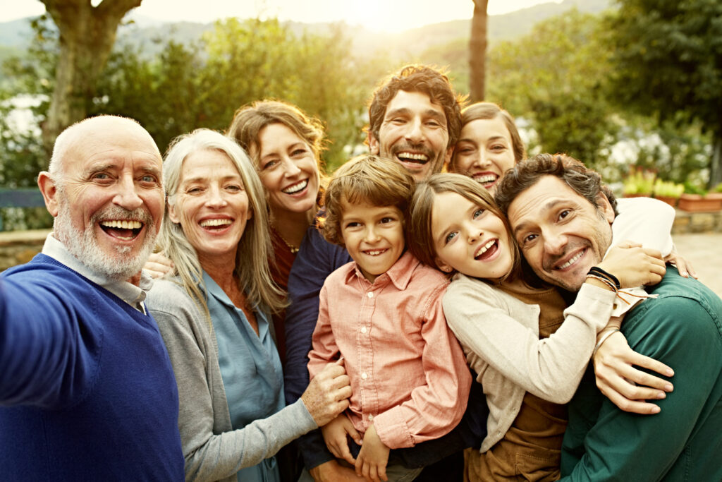 Cheerful multi-generation family at yard Cheerful multi-generational family embrace and smile